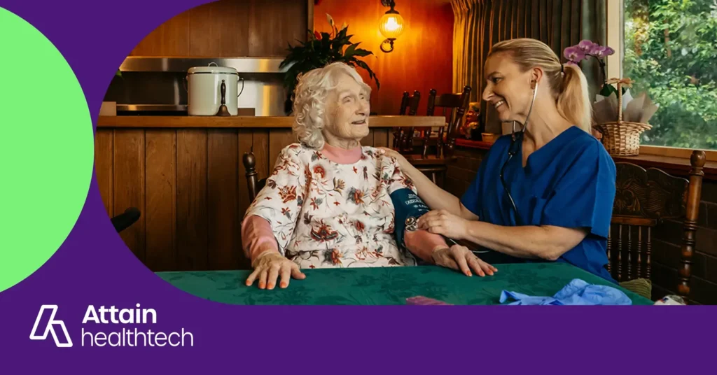 Registered Nurse in scrubs measures her older client's blood pressure.